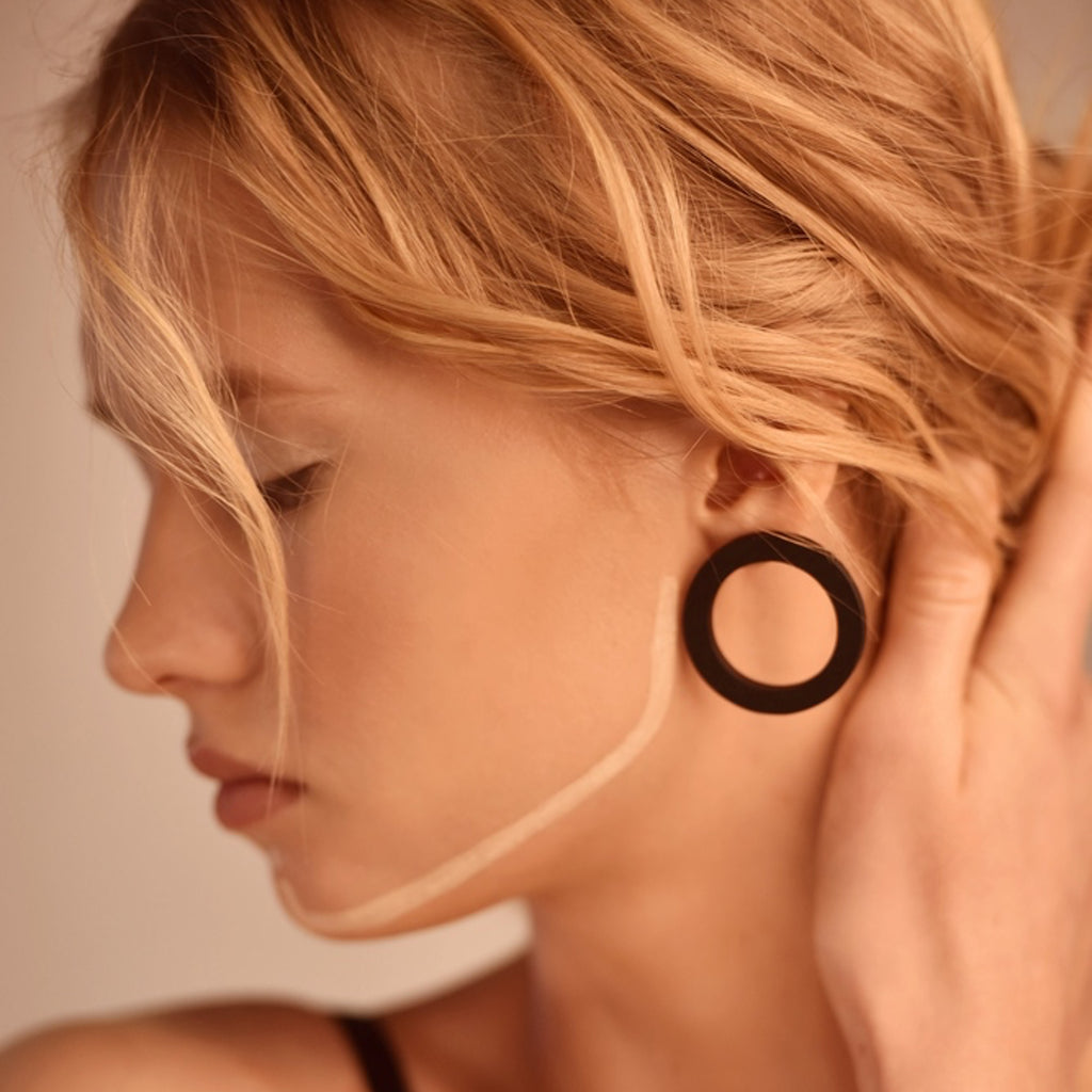 Model wearing Sustainable Walnut Wood O Designer Earrings on IndieFaves