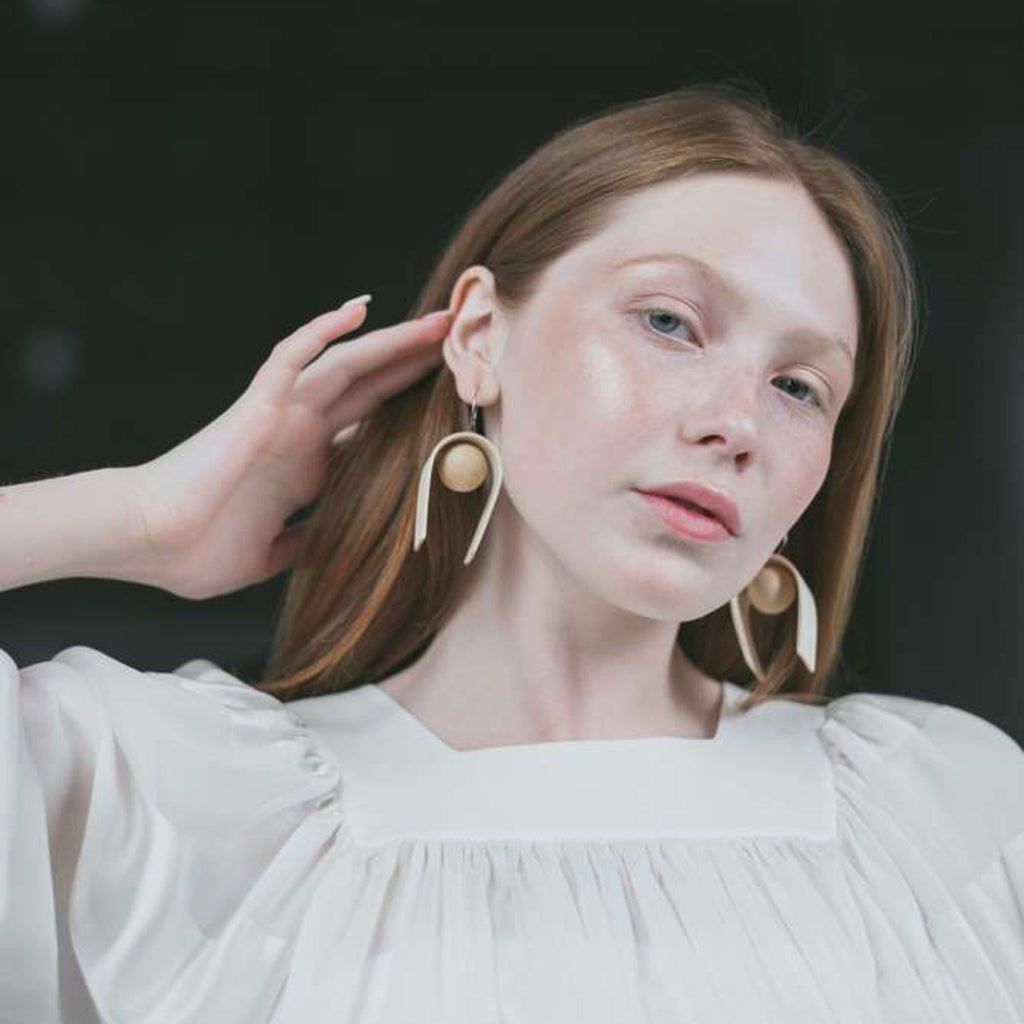 Model wearing Sustainable BirchWood Wooden Bent Designer Drop Earrings on IndieFaves