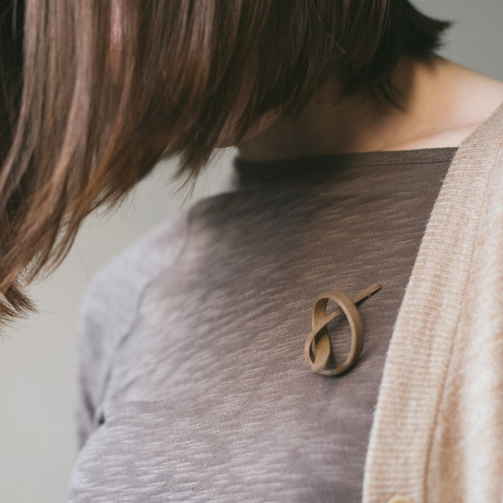 Model wearing Sustainable Walnut Wooden Alpha Designer Brooch on IndieFaves